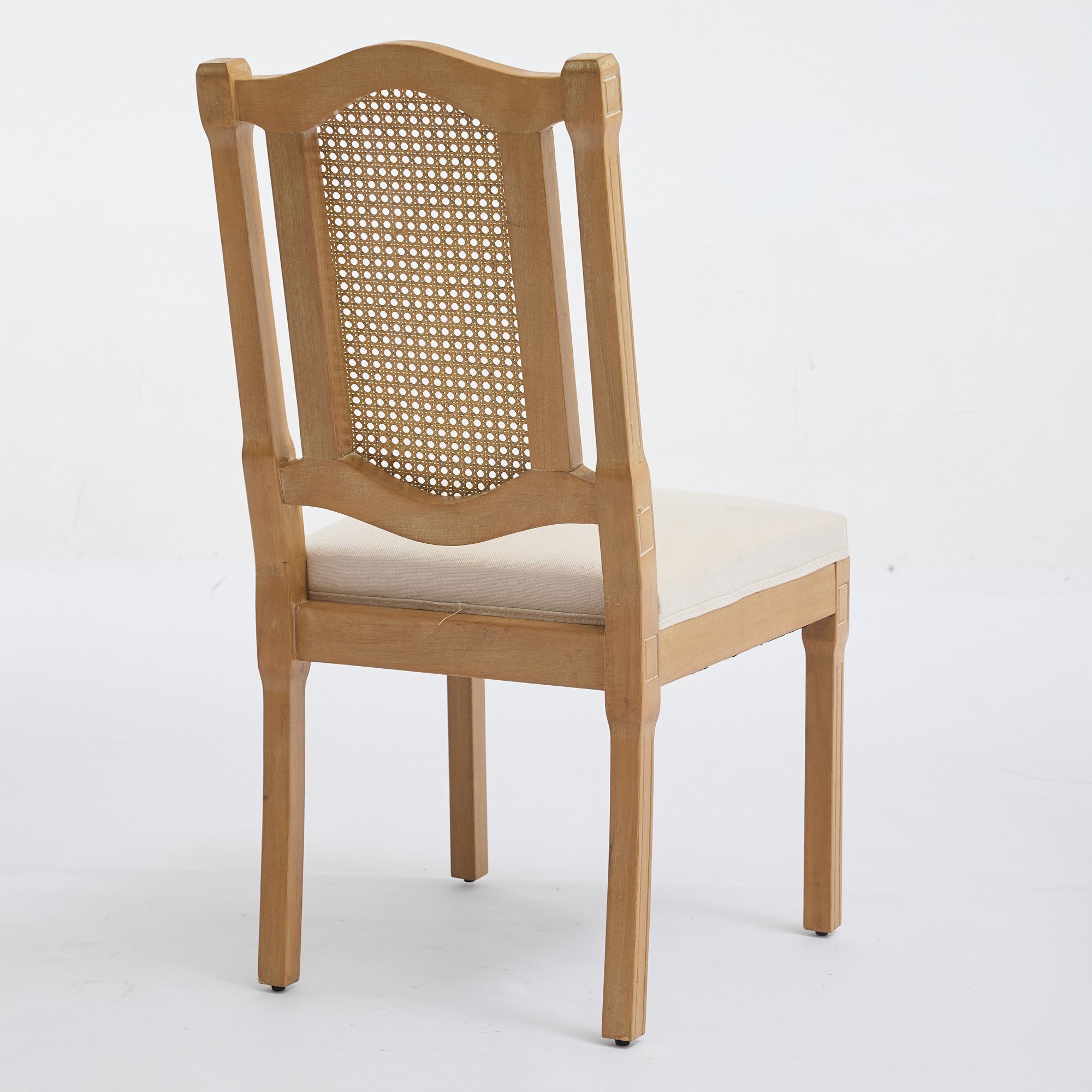 Shannon beige dining chair showing a rear angled view of the fluted wood and cane back