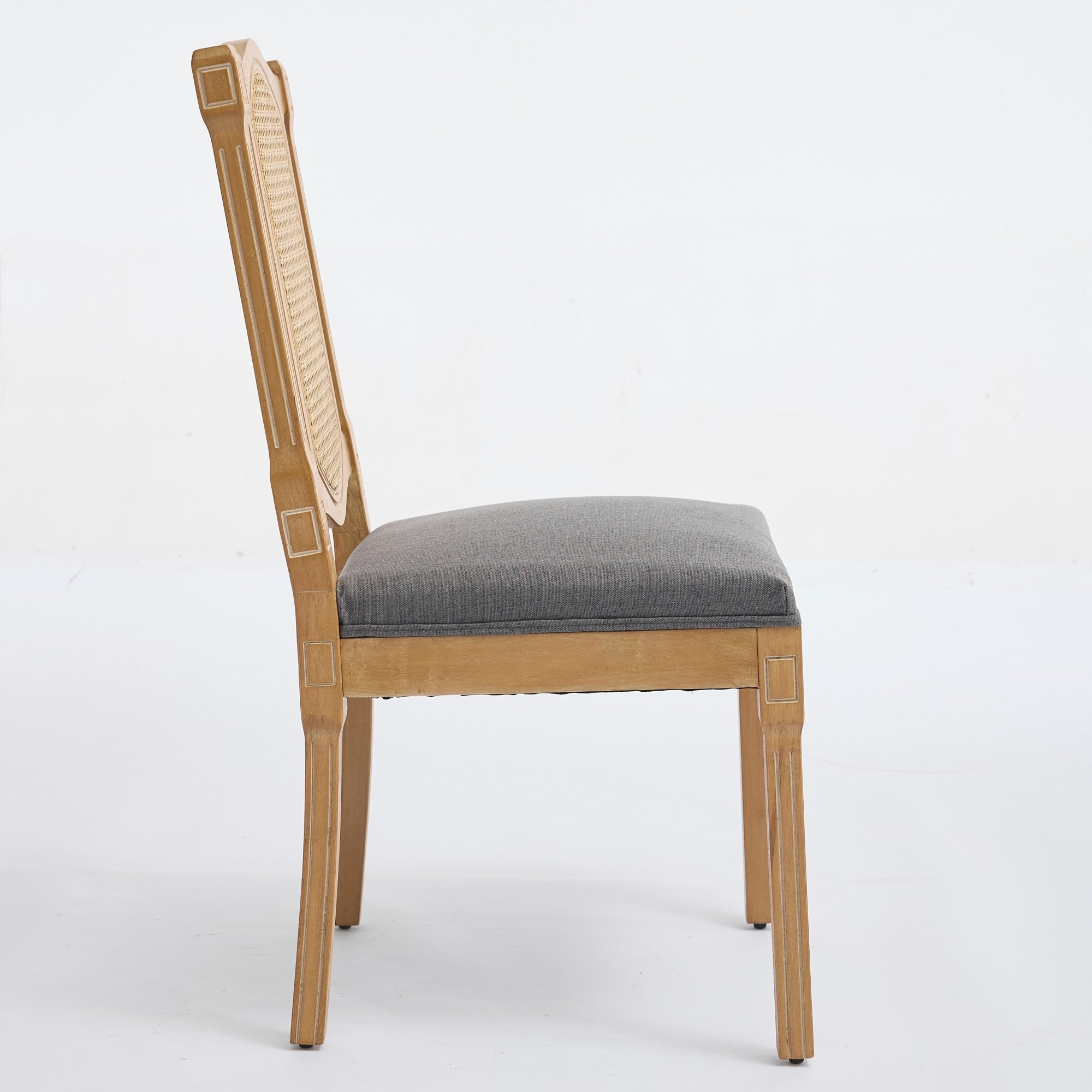 Shannon gray dining chair showing the side profile with a cane back and upholstered seat