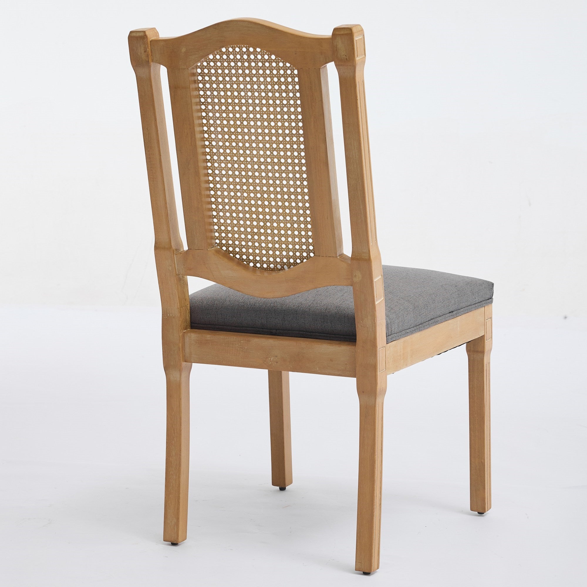 Shannon gray dining chair showing a rear angled view of the fluted wood and cane back
