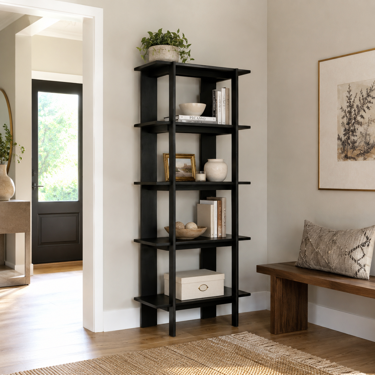 Sonnet black open bookcase showing books and decorative objects near a doorway and wood bench