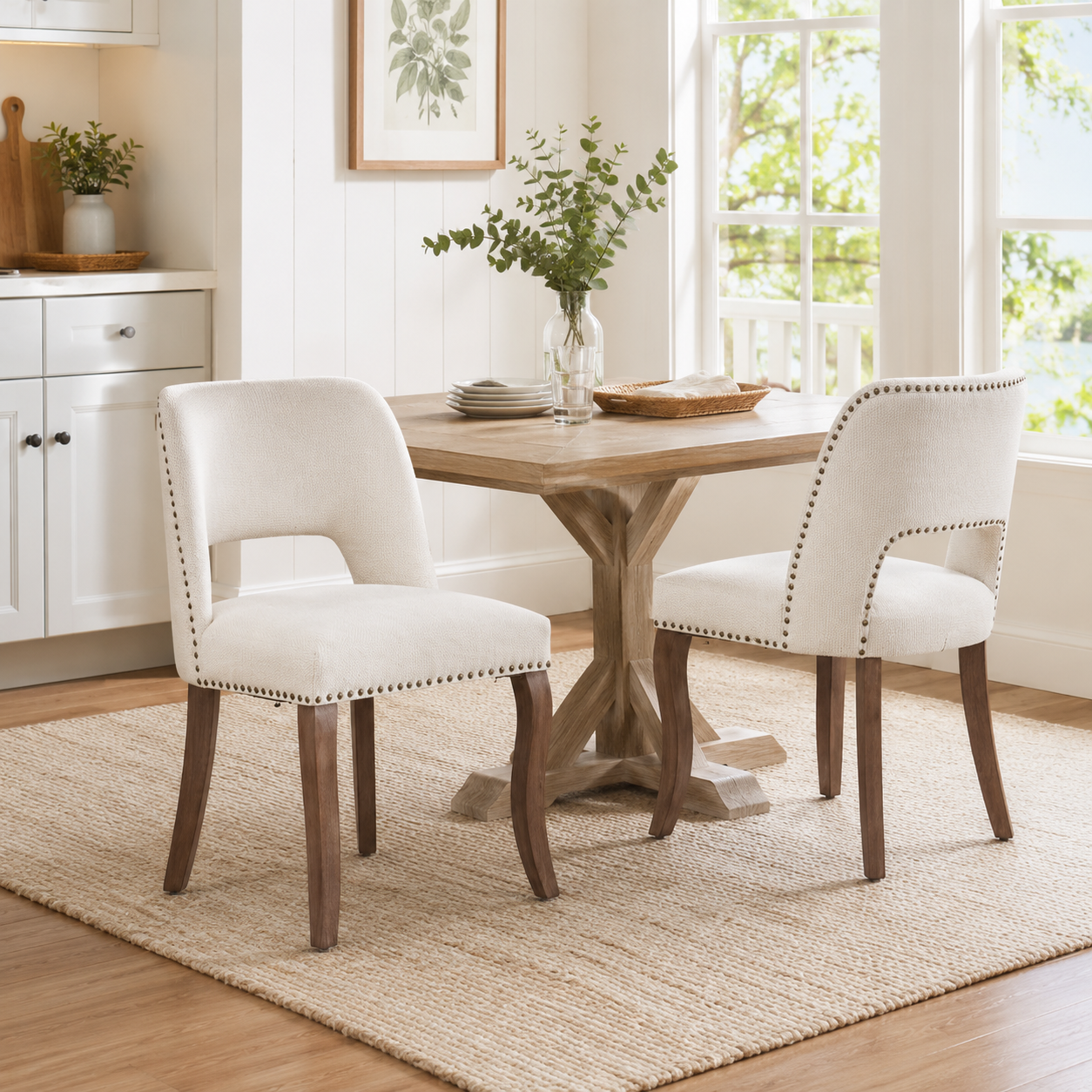 Tiberis beige dining chairs showing four chairs around a round pedestal dining table