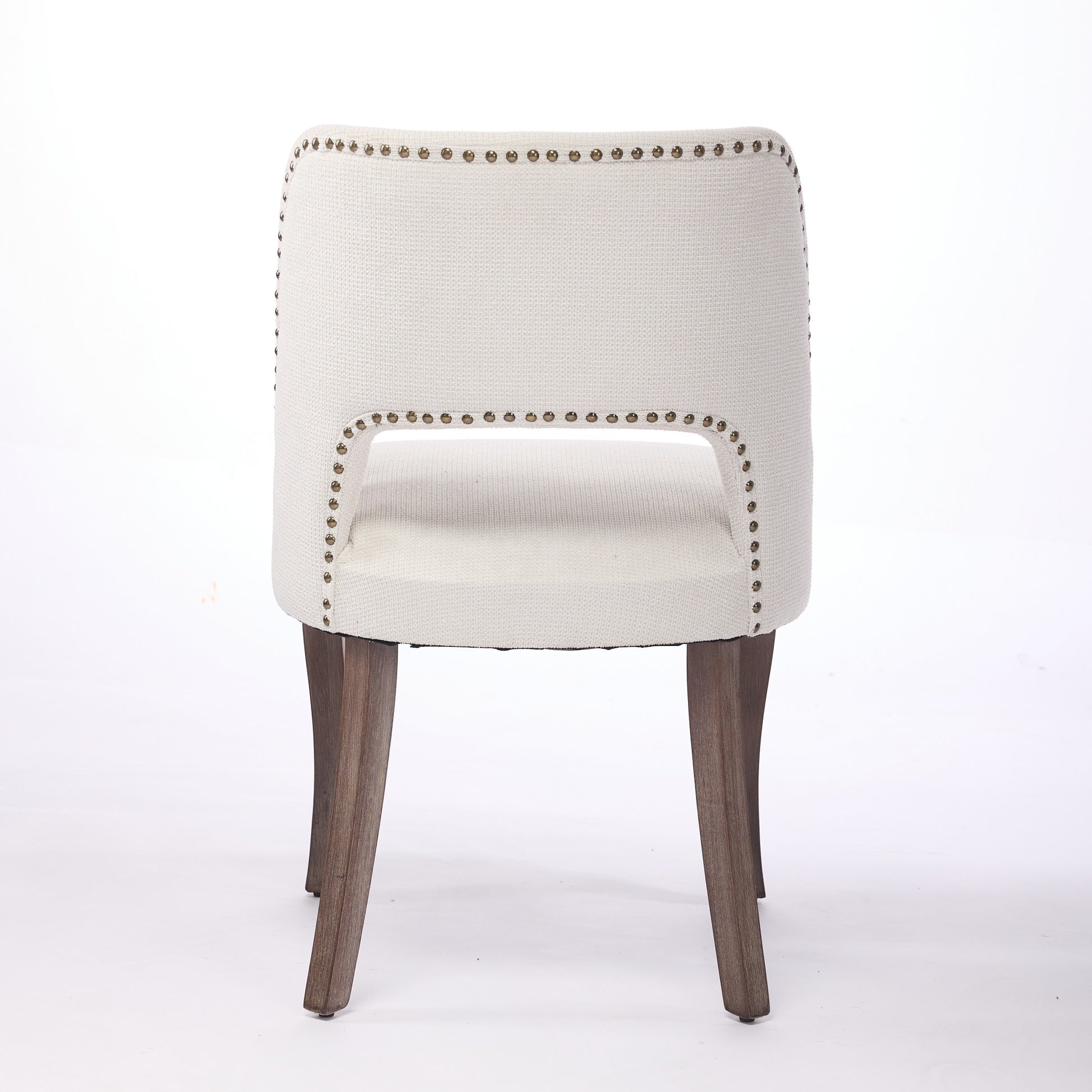 Tiberis beige dining chair showing the full rear view with an open cut-out back design