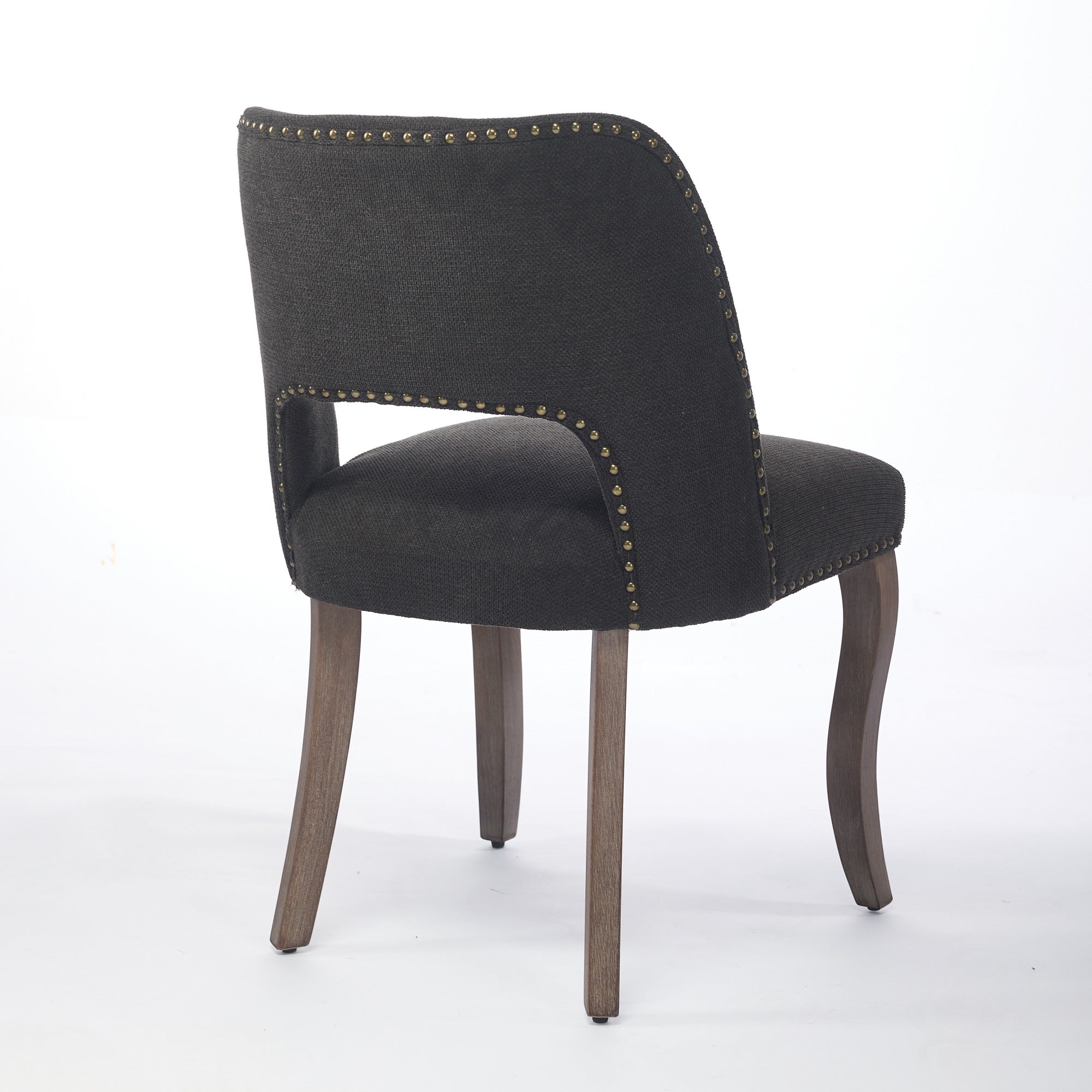 Tiberis black dining chair showing a rear angled view with nailhead trim and open back