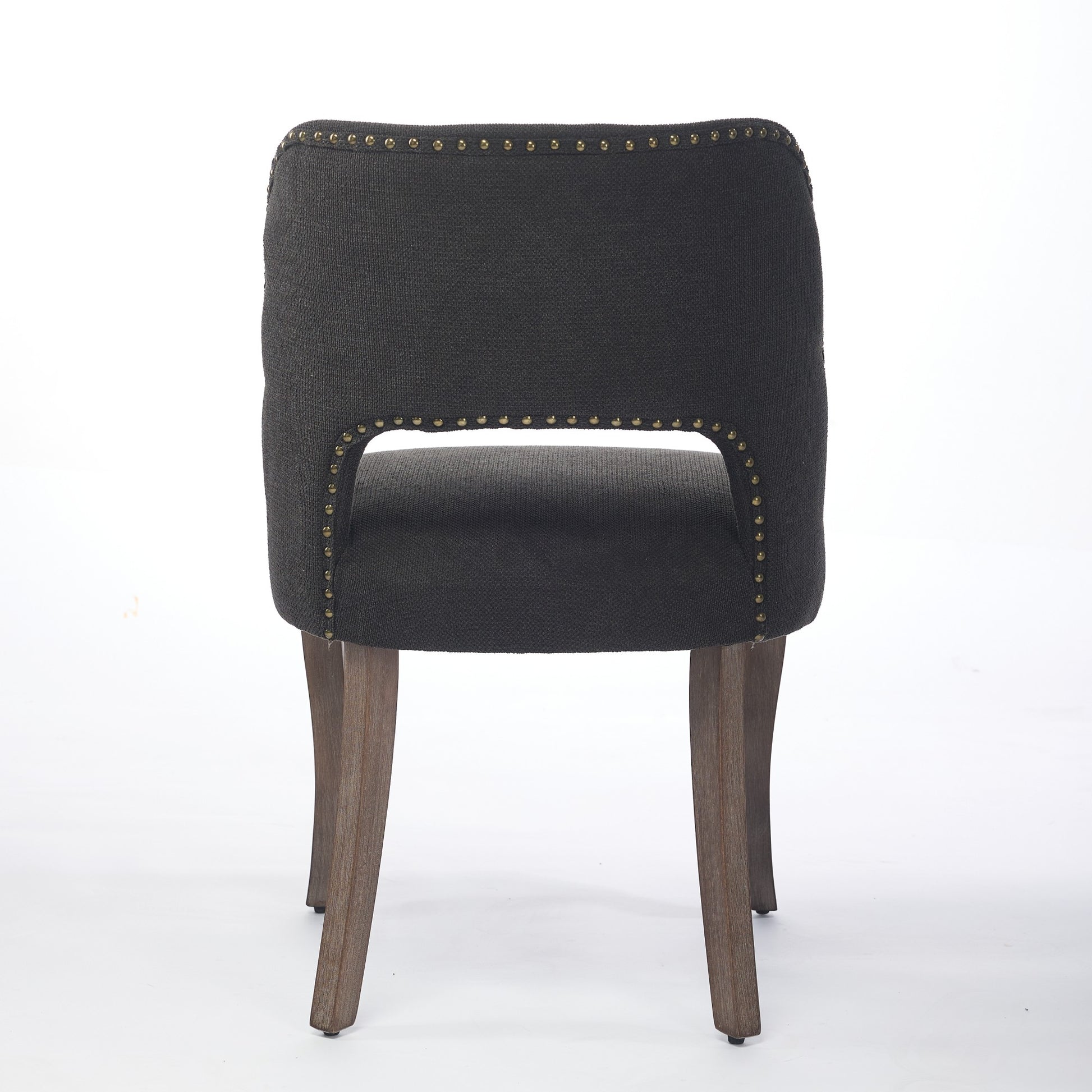 Tiberis black dining chair showing the full rear view with an open cut-out back and wood legs
