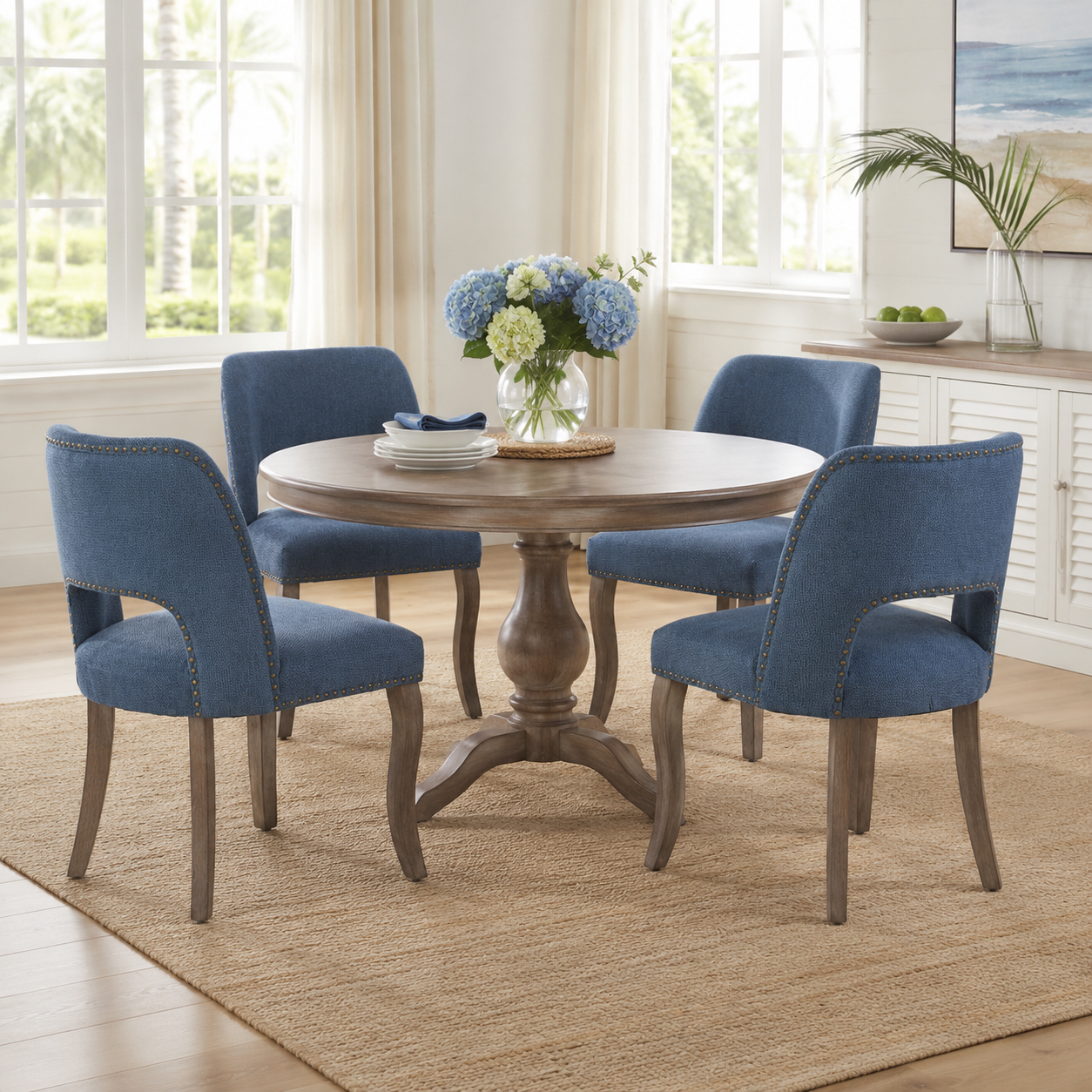 Tiberis blue dining chairs showing four chairs around a round table beside large windows