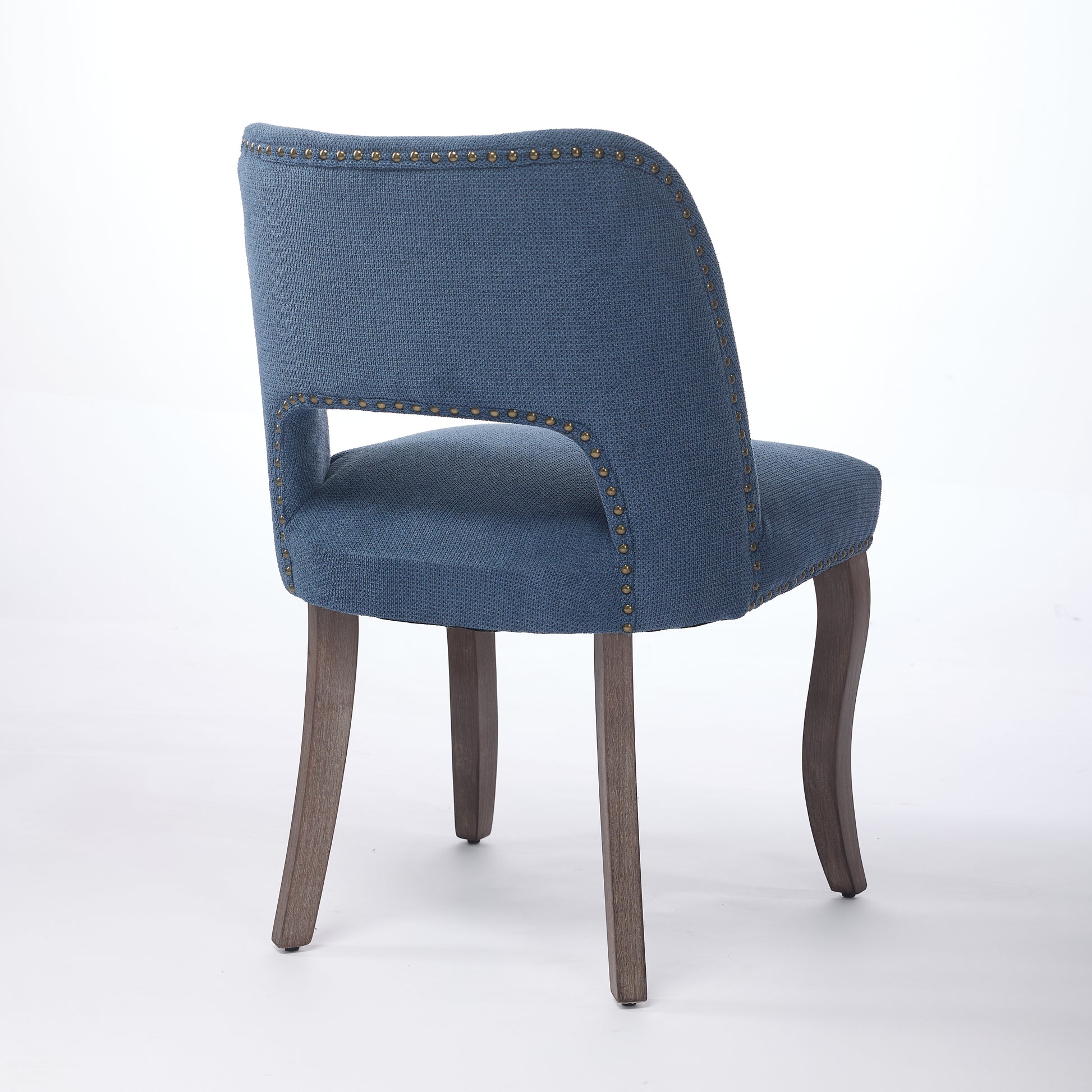 Tiberis blue dining chair showing a rear angled view of the open back and upholstered seat