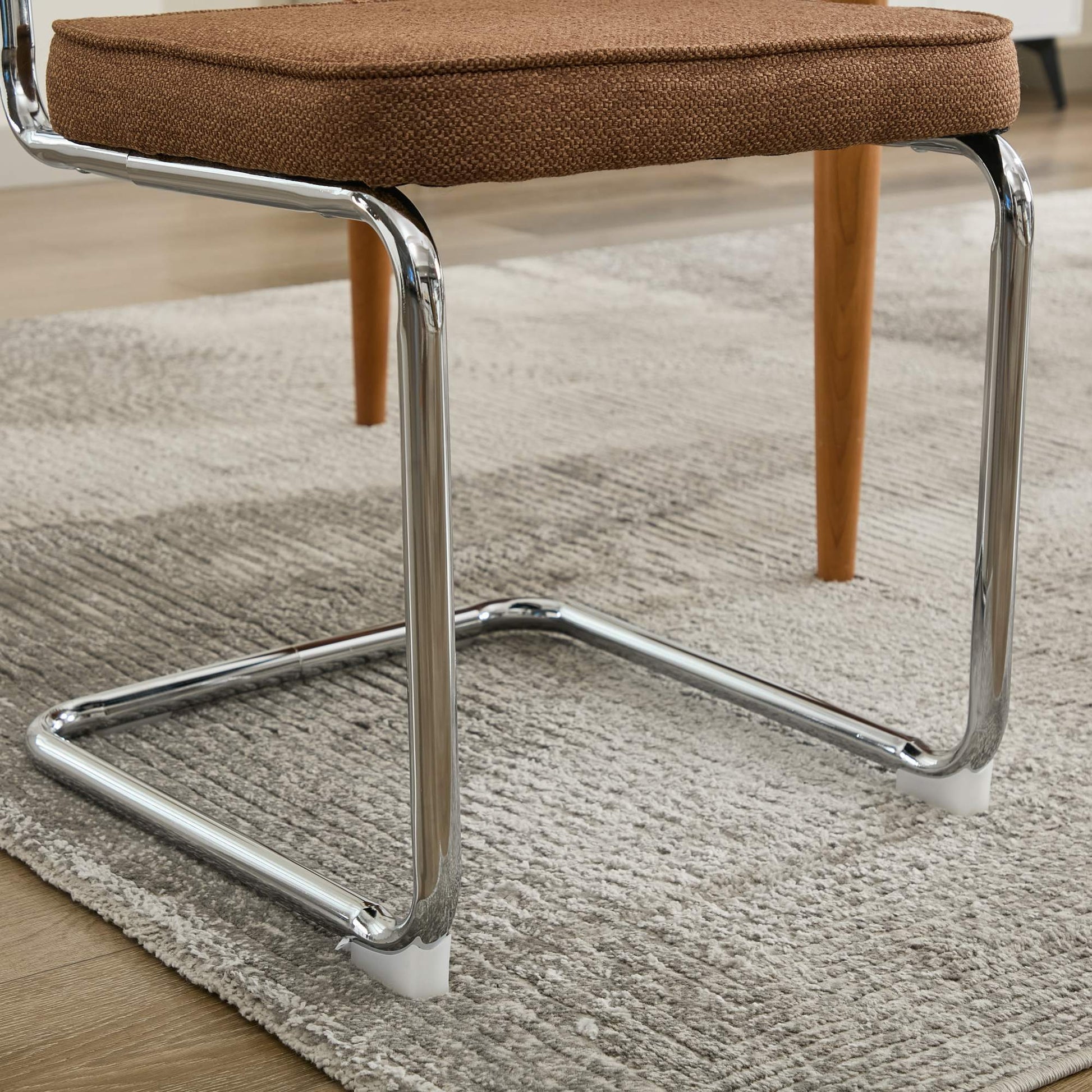Tigris brown dining chair close-up of the velvet seat and chrome base
