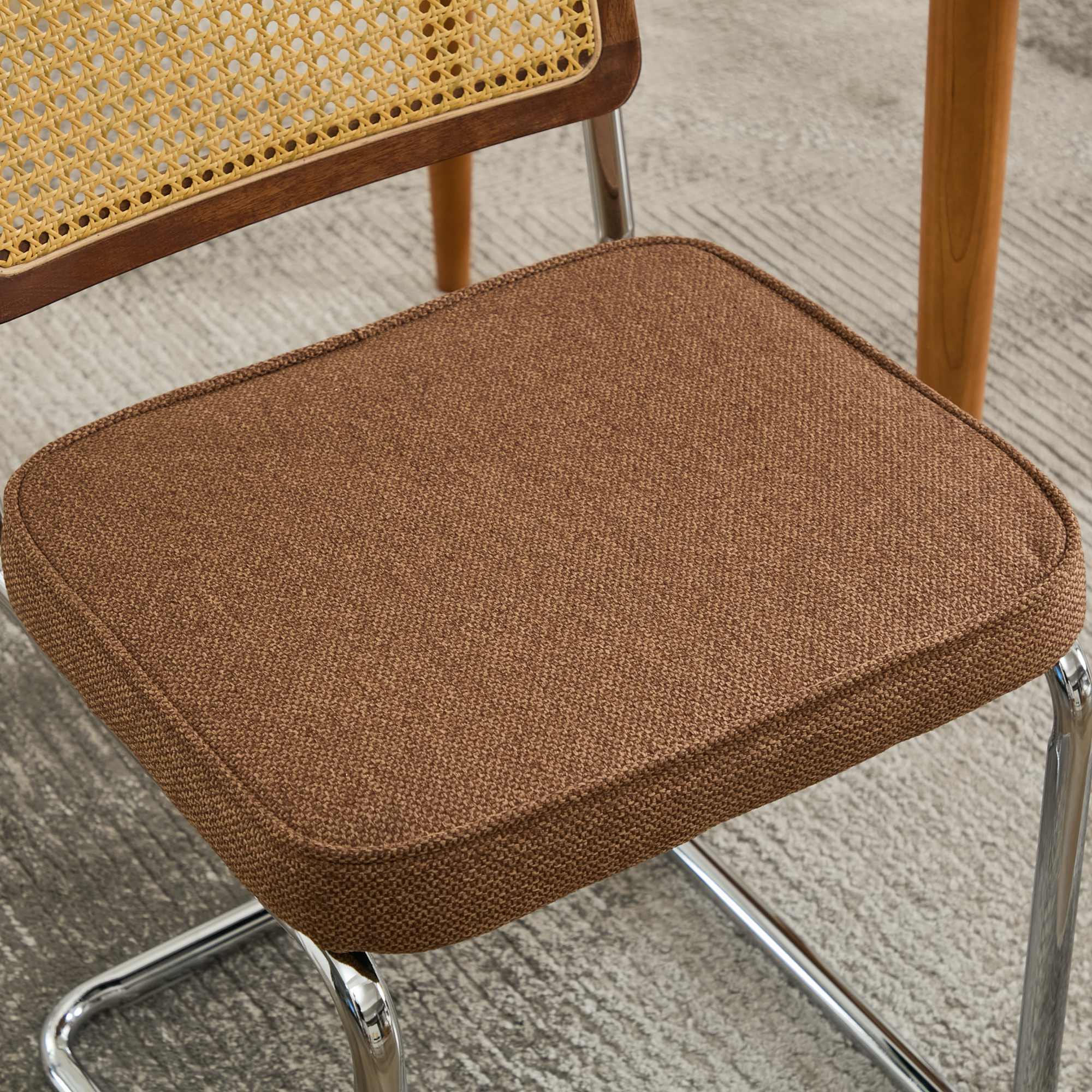 Tigris brown dining chair close-up of the velvet seat and chrome base