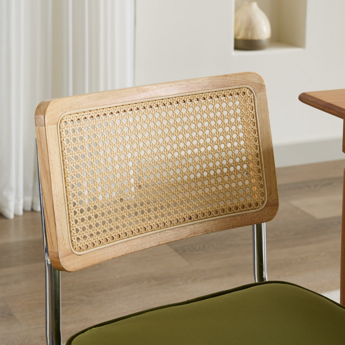 Tigris green dining chair close-up of the handwoven cane backrest and wood frame