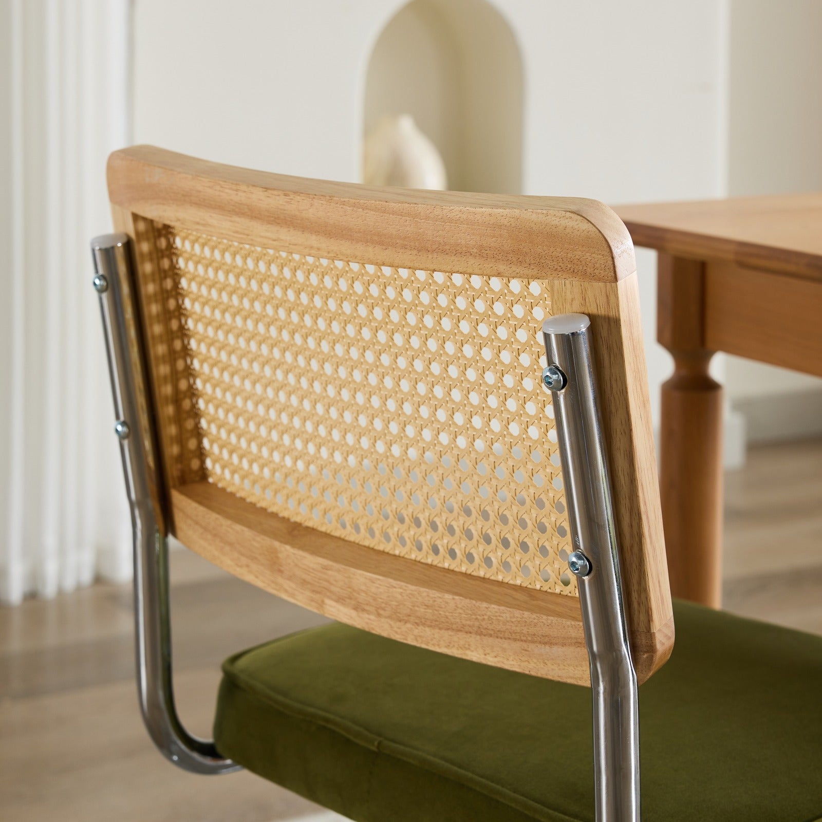 Tigris green dining chair close-up of the chrome cantilever base
