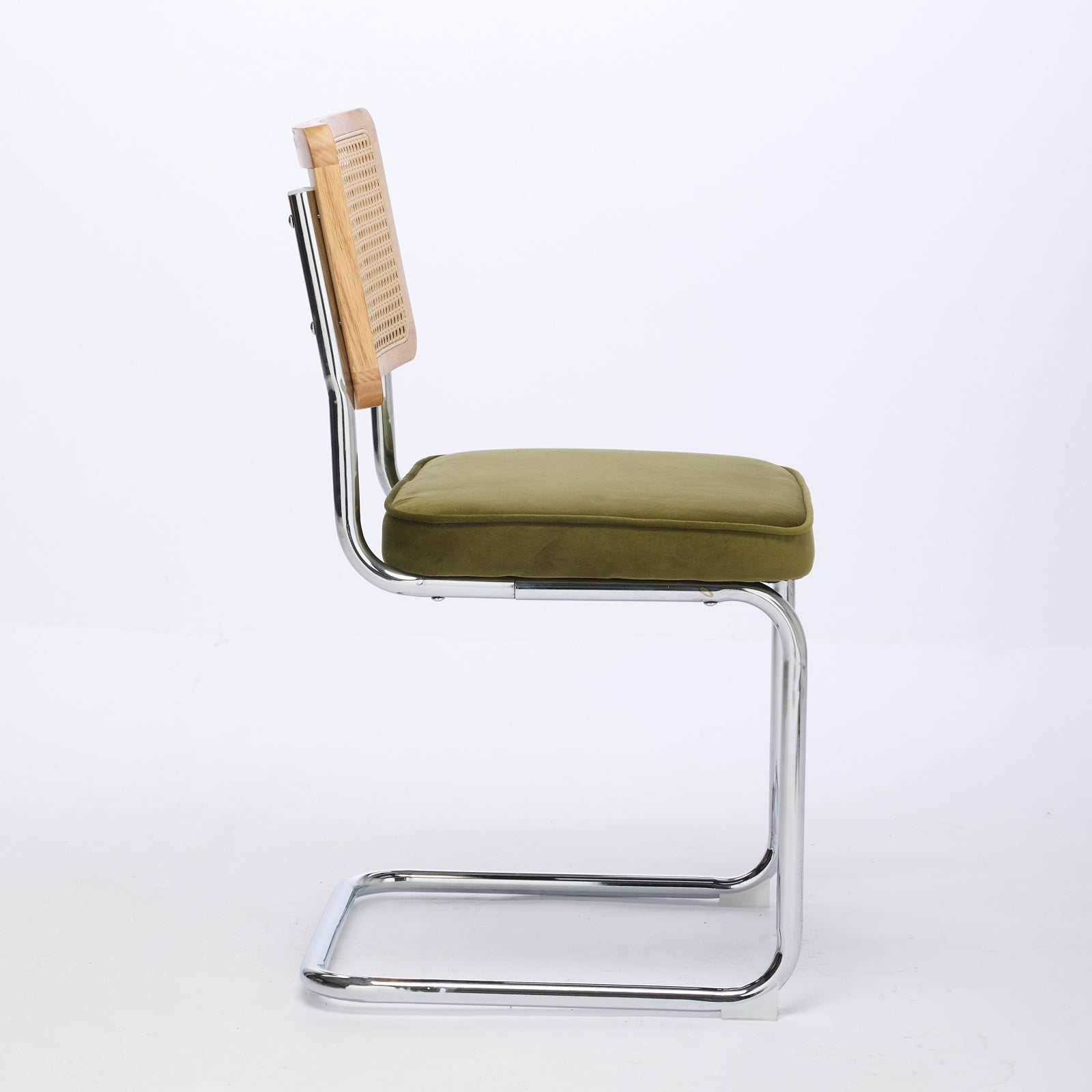 Tigris green velvet cantilever dining chair side view on white background
