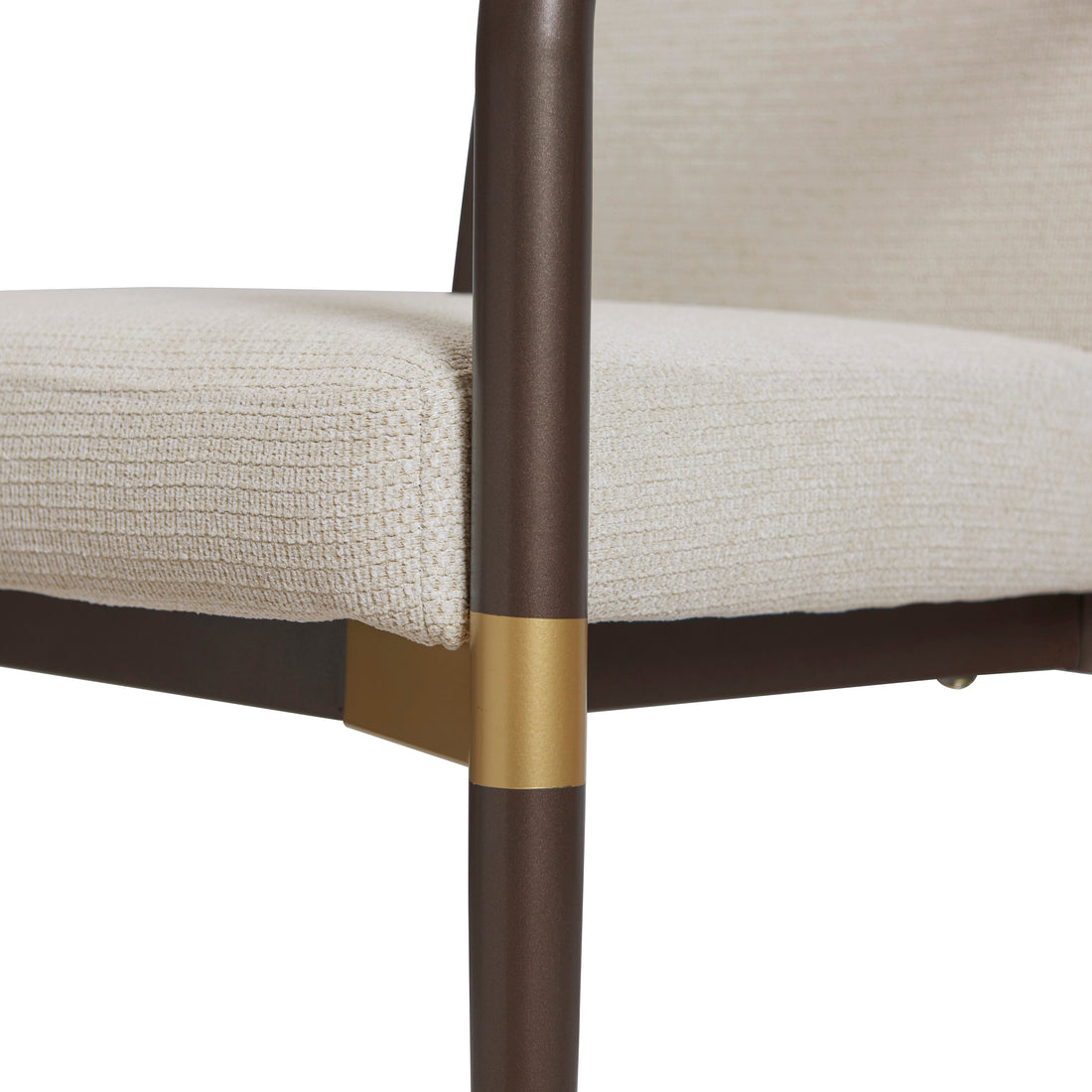 Trasimeno brown dining armchair close-up of the brass-tone accent on the front leg