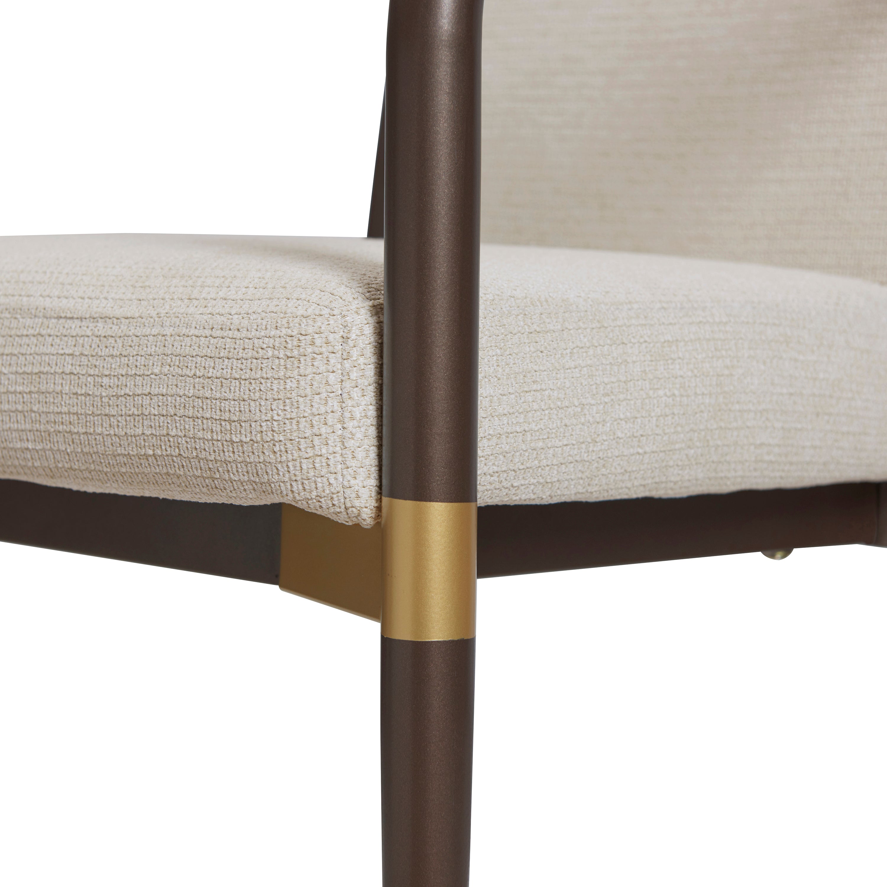 Trasimeno brown dining armchair close-up of the brass-tone accent on the front leg