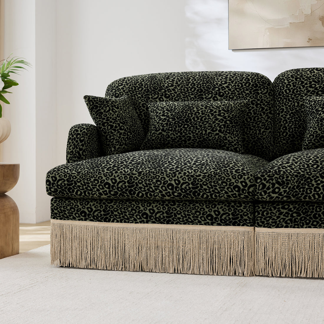 Tucson dark green leopard chenille sectional sofa showing chaise seat and fringe trim detail