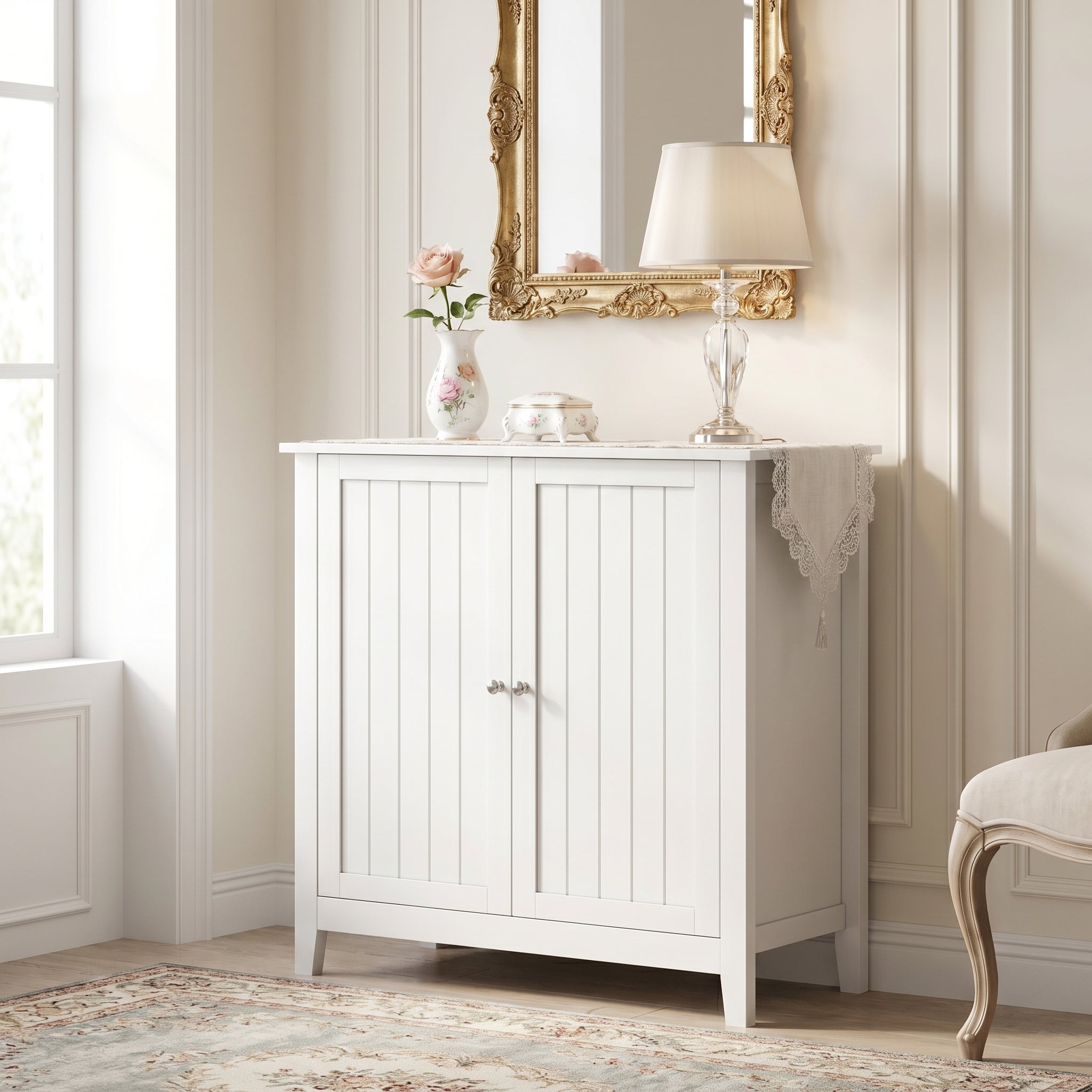 Tudor white storage cabinet showing a styled entryway scene with mirror and plants