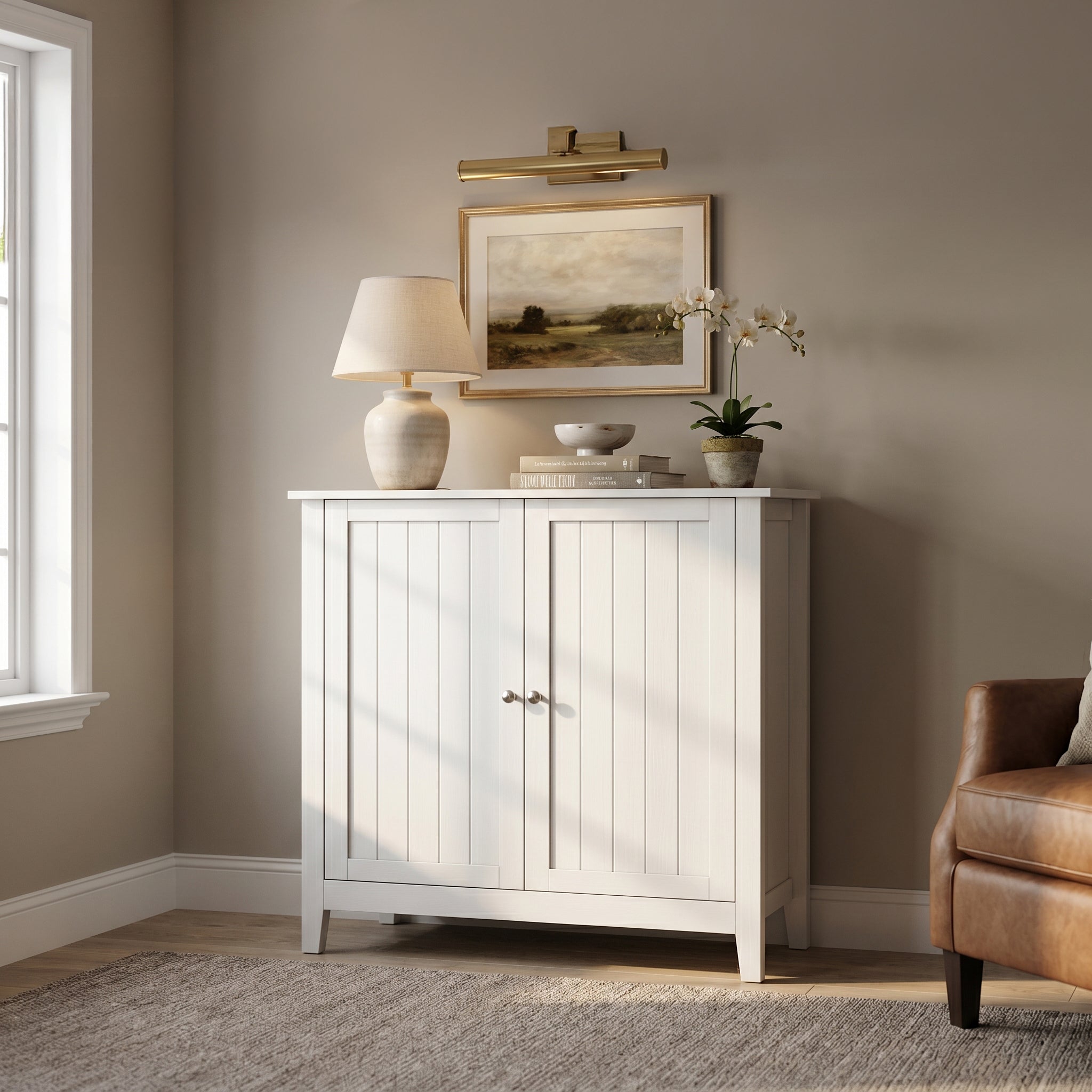 Tudor white storage cabinet showing a warm interior scene with framed wall art