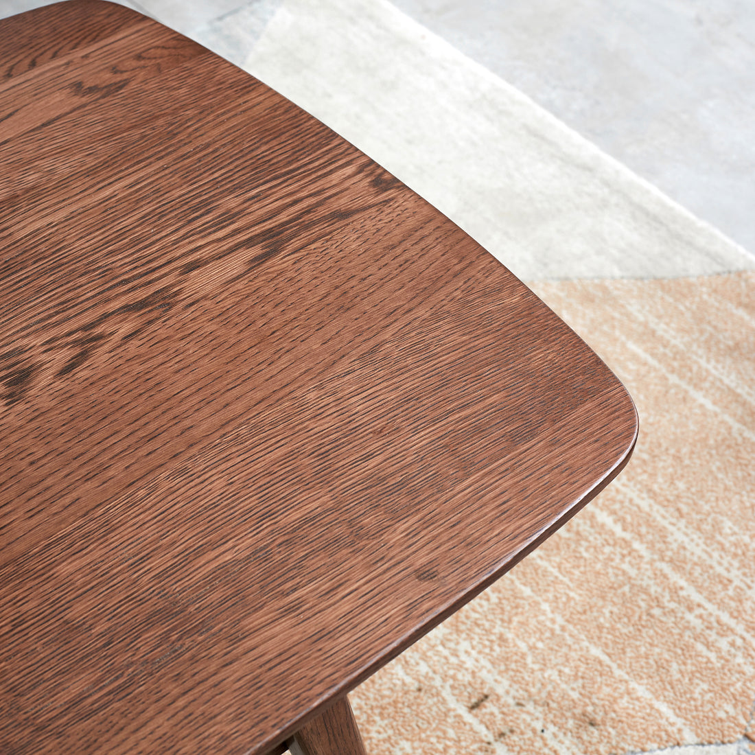 Tuscany walnut coffee table showing rounded solid wood corner detail