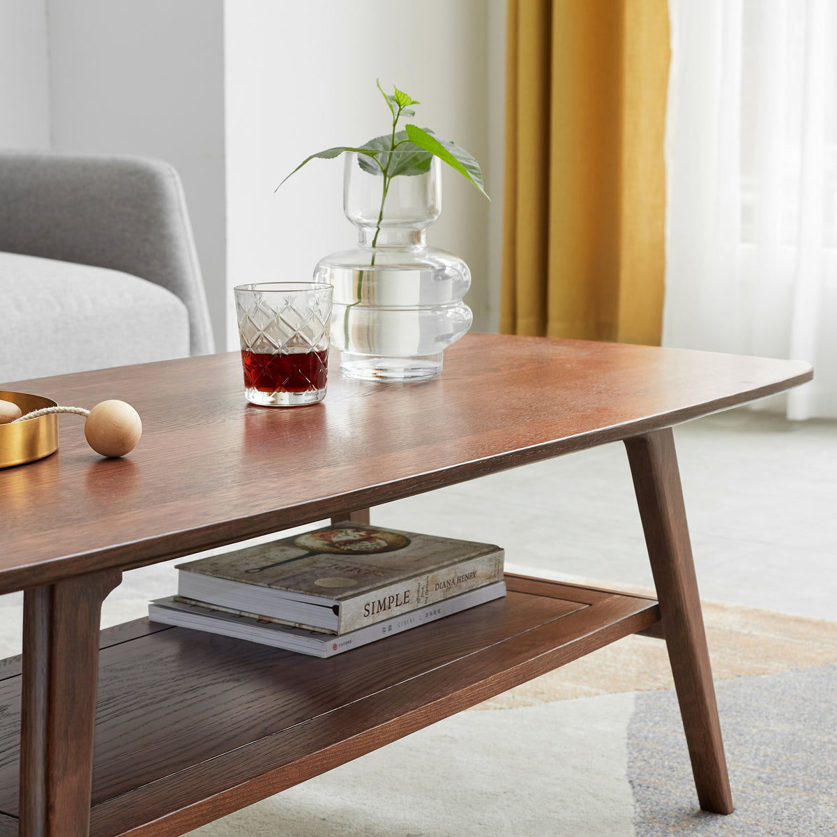 Tuscany walnut coffee table showing open storage shelf and tapered leg detail
