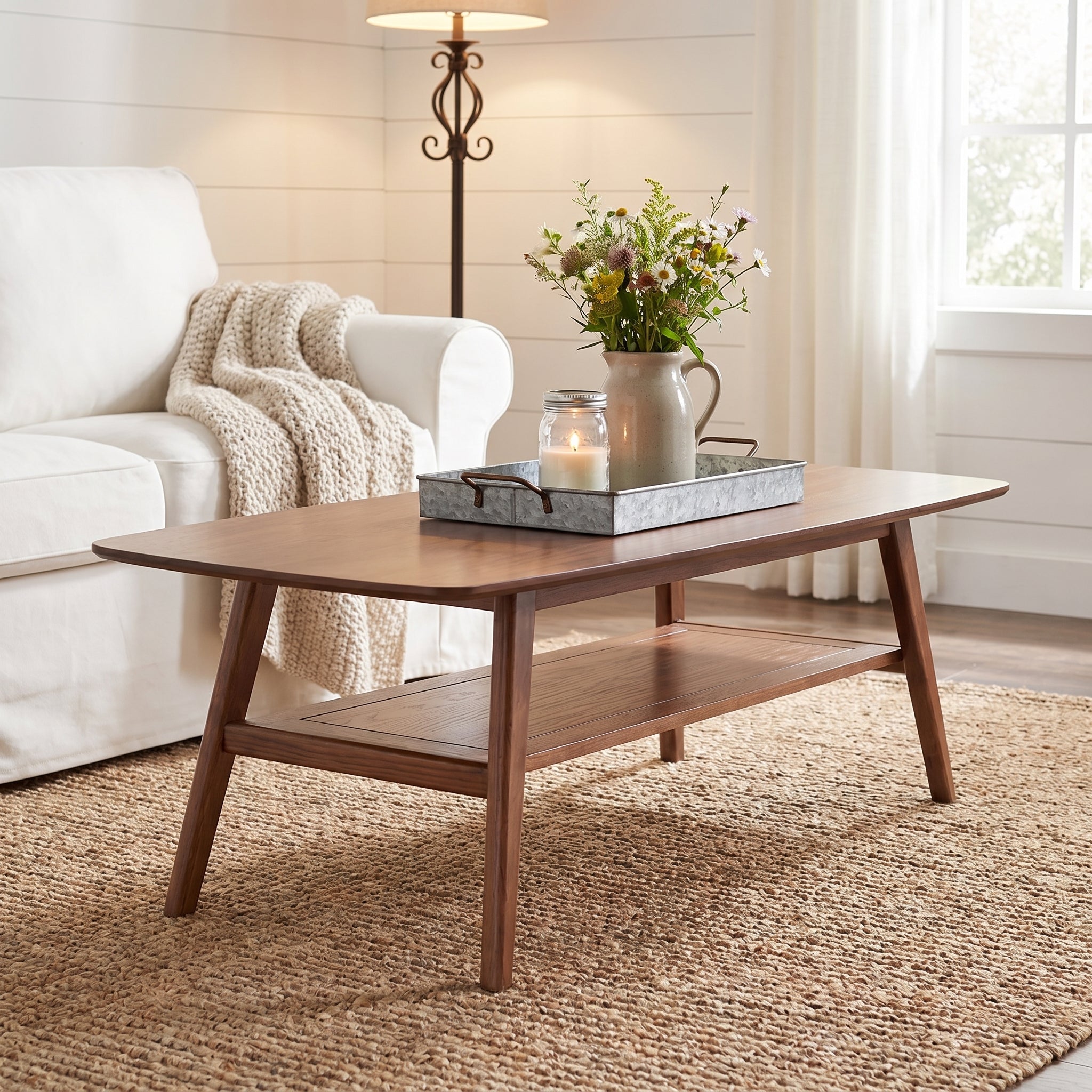 Tuscany walnut coffee table showing a styled tabletop beside a beige sofa