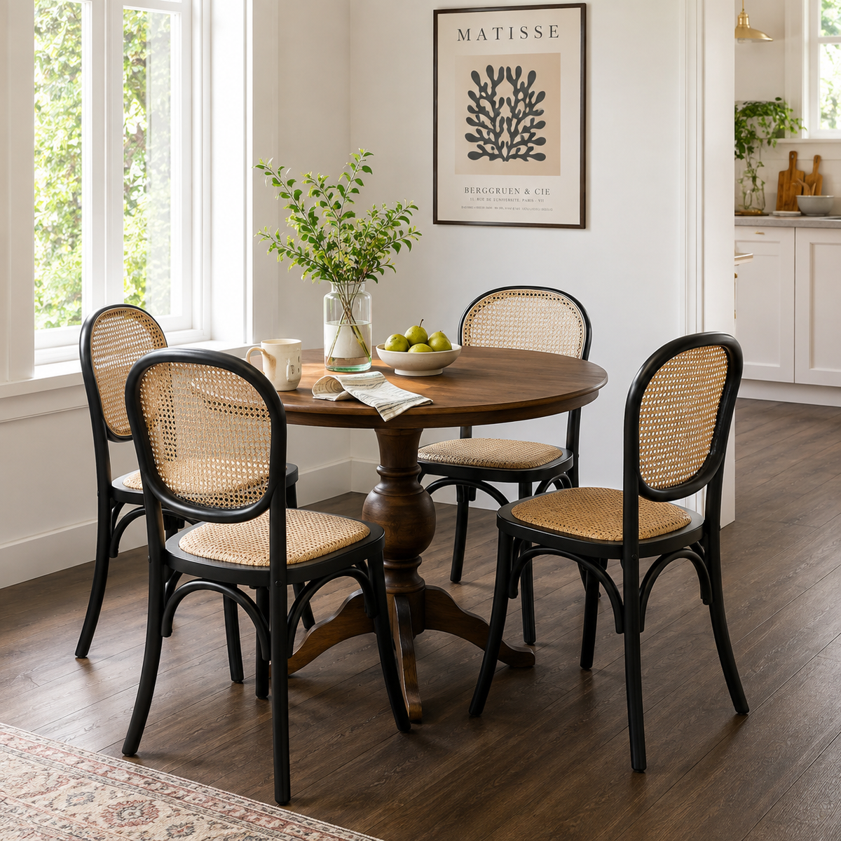 Vattern black bentwood dining chairs around a dark pedestal dining table