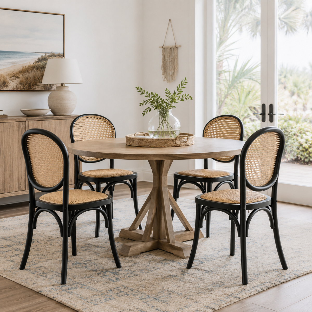 Vattern black rattan cane dining chairs in a cozy dining room with natural light