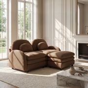 Ventura camel modular sofa in bright living room with tall windows and fireplace