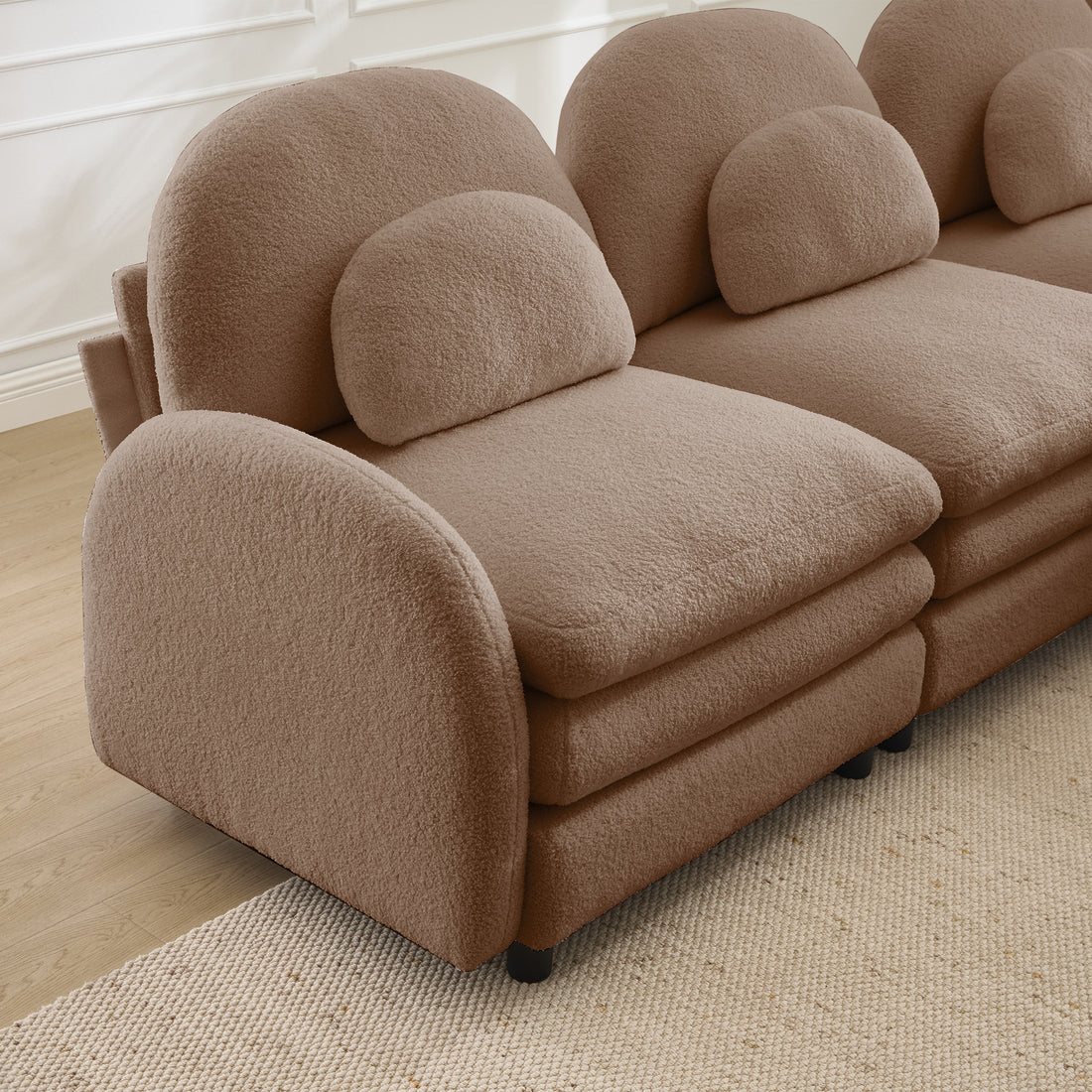 Ventura camel sectional sofa showing curved armrest and layered cushion detail