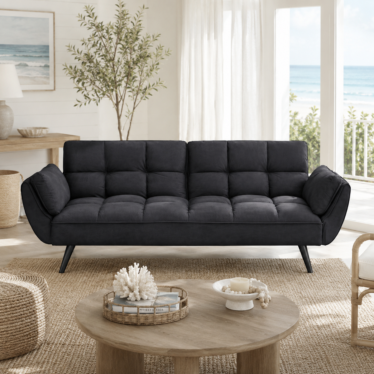 Wellington black futon sofa bed with tufted cushions in a styled interior