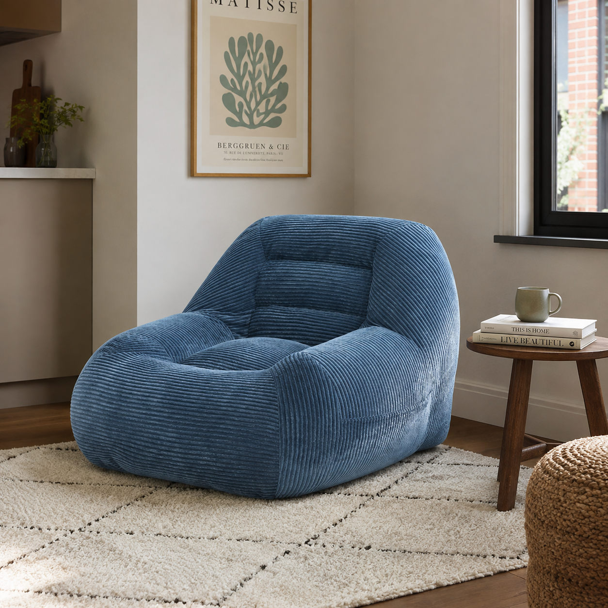 Westwood blue bean bag armchair shown beside a window and side table in a bright neutral room