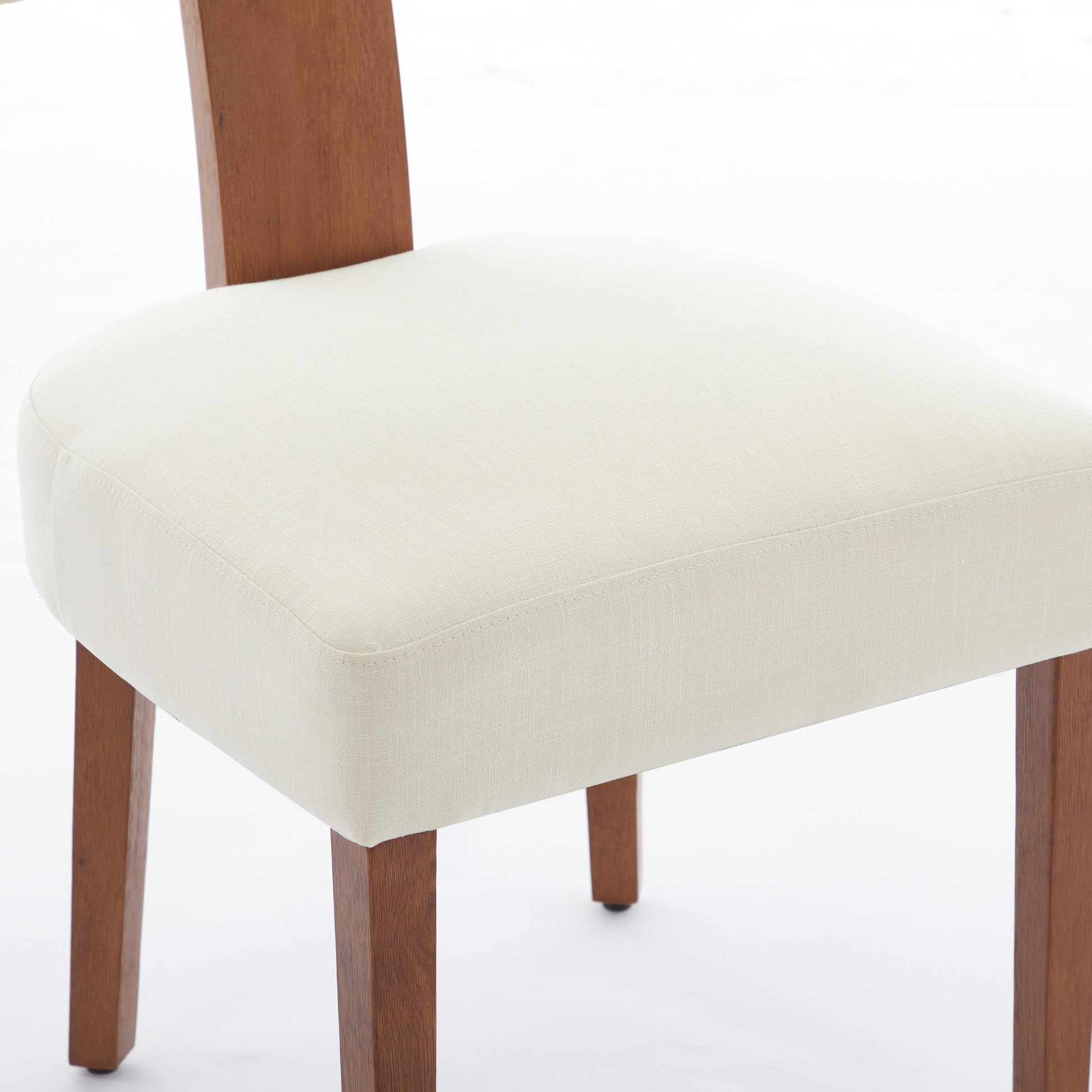 Yukon white linen dining chair close-up of the upholstered seat and curved backrest