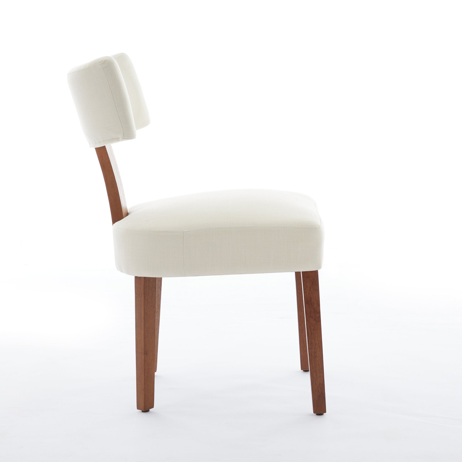 Yukon white linen dining chair side view with solid wood legs on white background